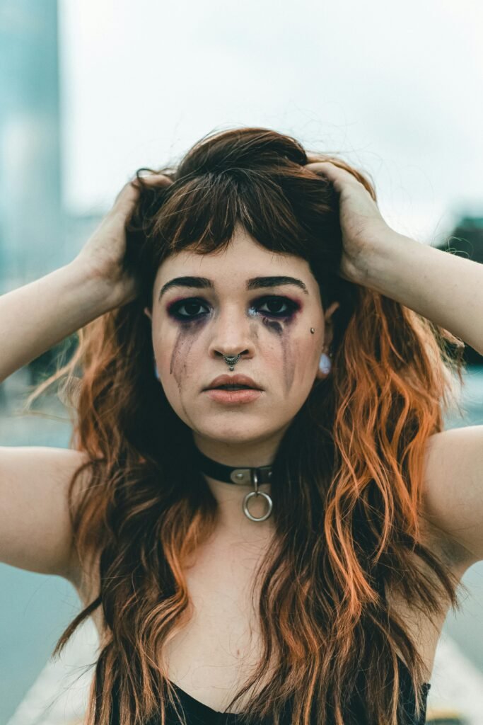 a beautiful woman with leaking makeup because she is experiencing emotional breakdown crying